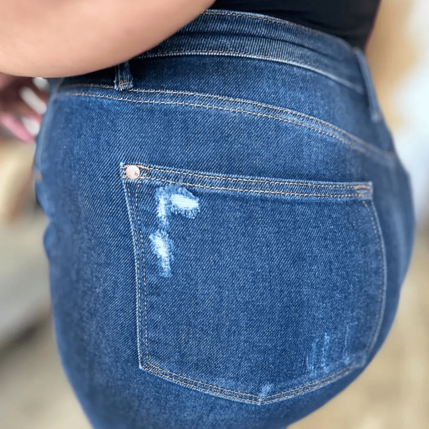 Close-up of the raw hem finish on Judy Blue straight-leg jeans.