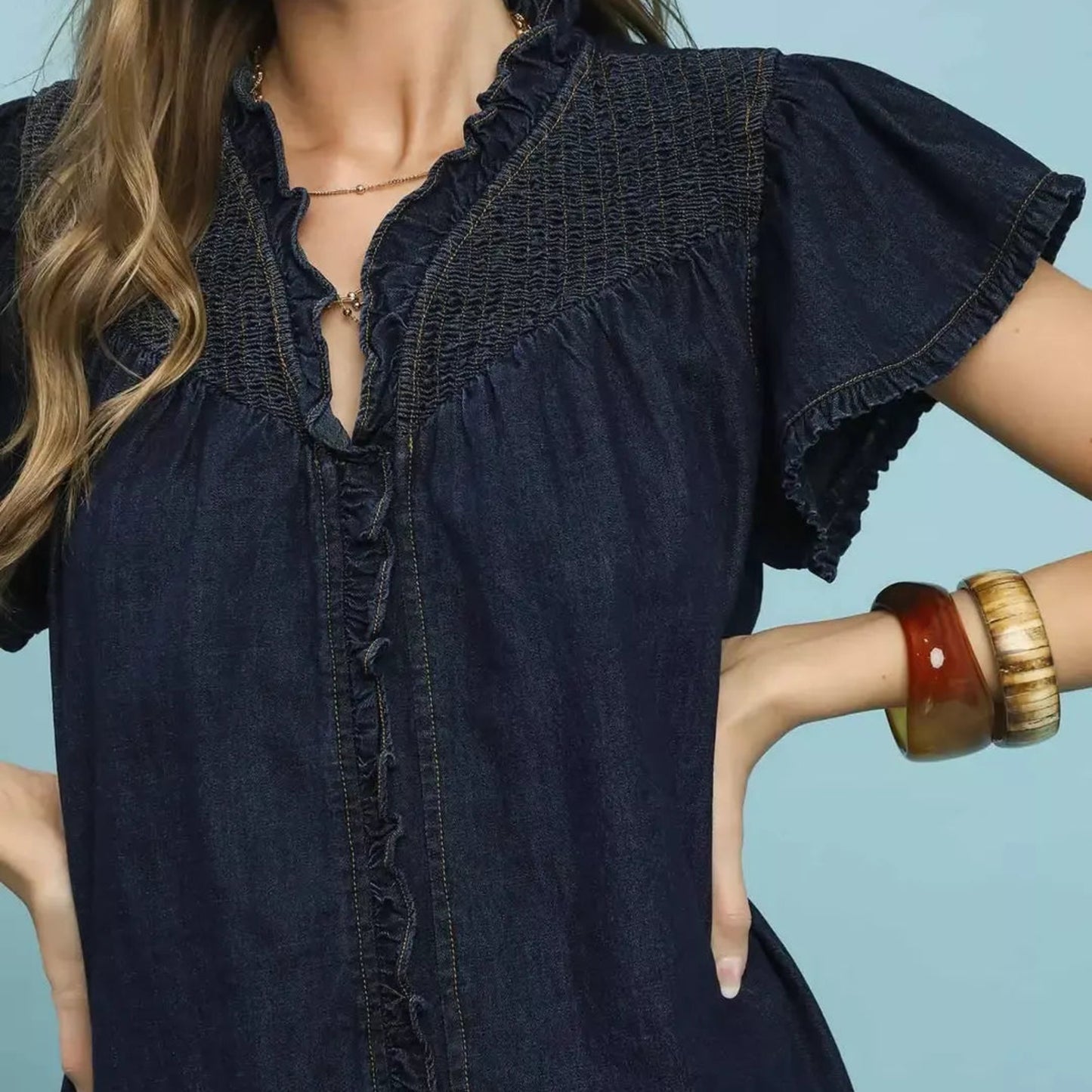 Detailed shot of the 100% cotton texture and faded wash on the umgee ruffled washed denim dress