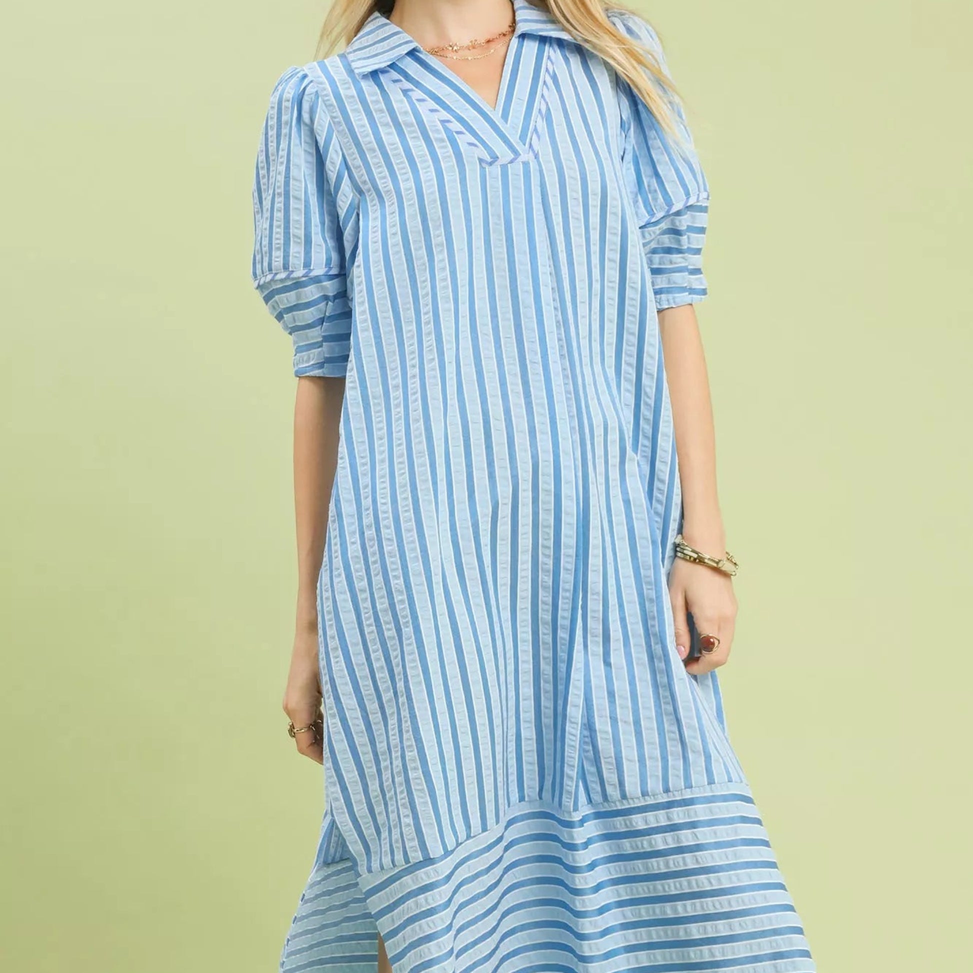Front view of a breezy blue striped Umgee midi dress with puff sleeves from Solazura Boutique