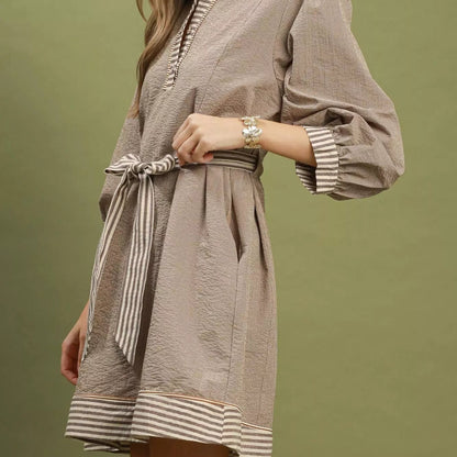Close up detail of the matching tie belt on a brown Umgee striped mini dress from Solazura Boutique