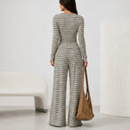 Back view of black 2 piece women's striped pants set with long sleeve cardigan and wide leg pants