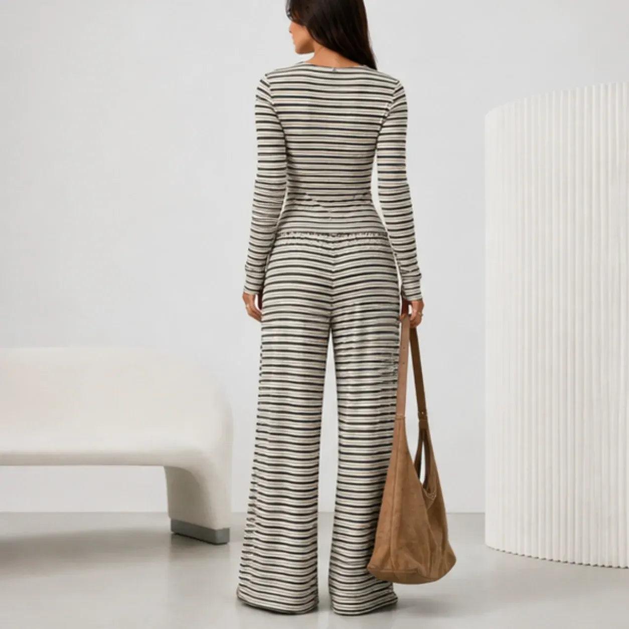 Back view of black 2 piece women's striped pants set with long sleeve cardigan and wide leg pants