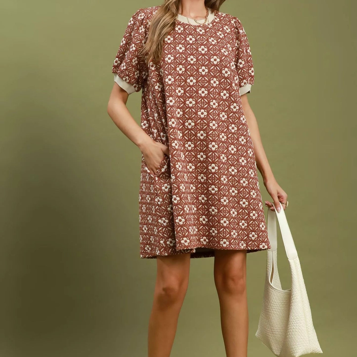 Model wearing a bohemian style rust Umgee floral puff sleeve mini dress from Solazura Boutique