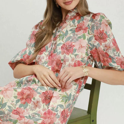 Model wearing a bohemian style Umgee mixed floral print smocked cuff dress from Solazura Boutique