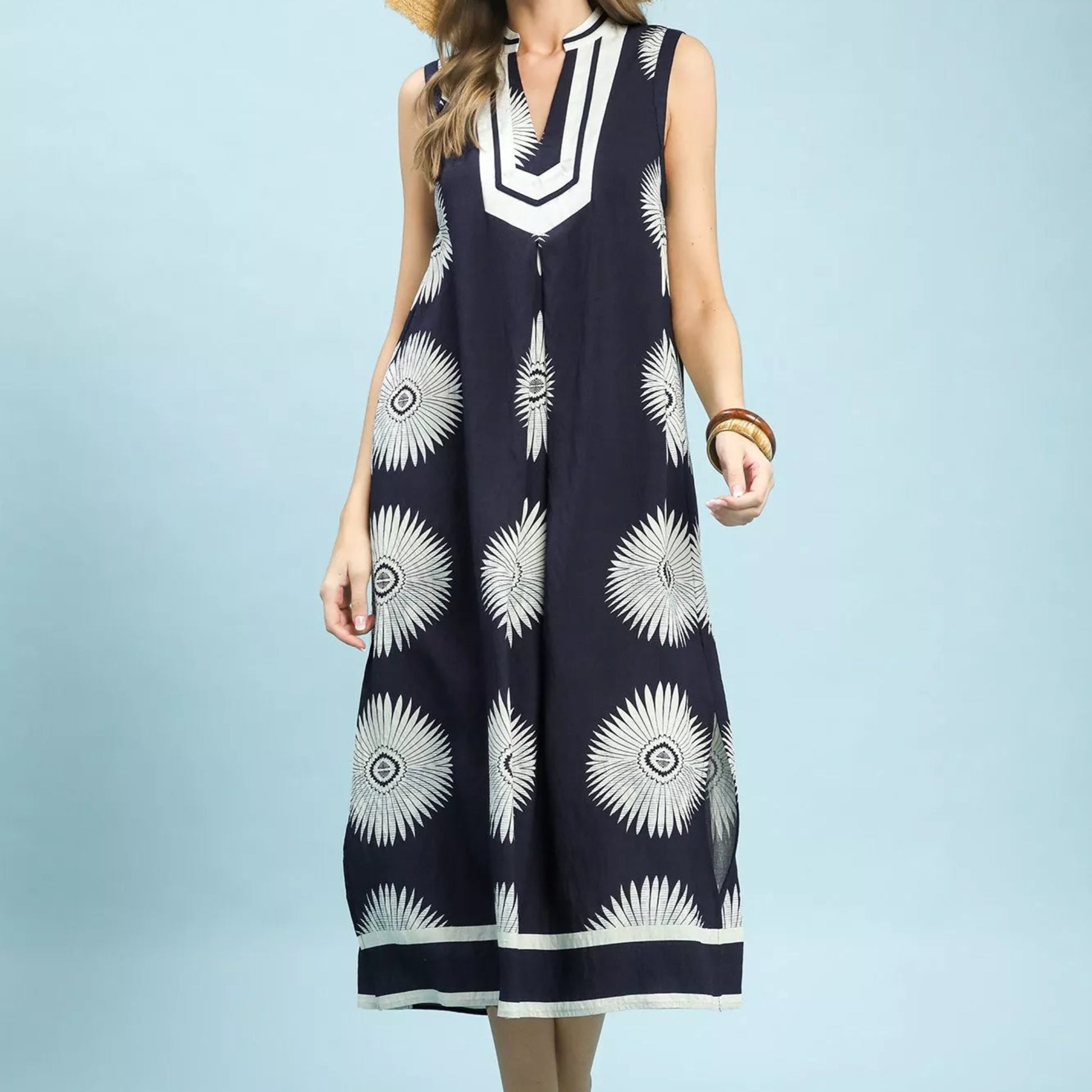 Front view of a loose flowing navy Umgee midi dress with a geometric print from Solazura Boutique