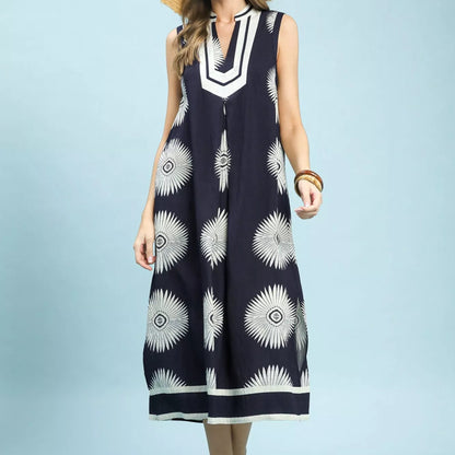 Front view of a loose flowing navy Umgee midi dress with a geometric print from Solazura Boutique