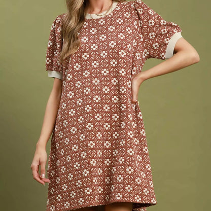 Front view of a casual rust floral Umgee mini dress with romantic puff sleeves from Solazura Boutique