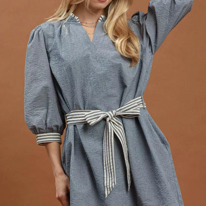 Close up detail of the adjustable drawstring tie waist on the denim Umgee mini dress from Solazura Boutique