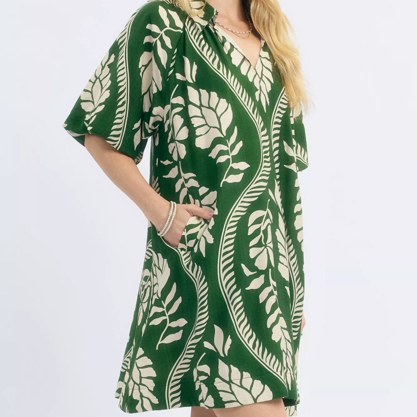 Close up detail of the flattering neckline and texturized cream green ogee print fabric from Solazura Boutique
