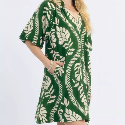 Close up detail of the flattering neckline and texturized cream green ogee print fabric from Solazura Boutique
