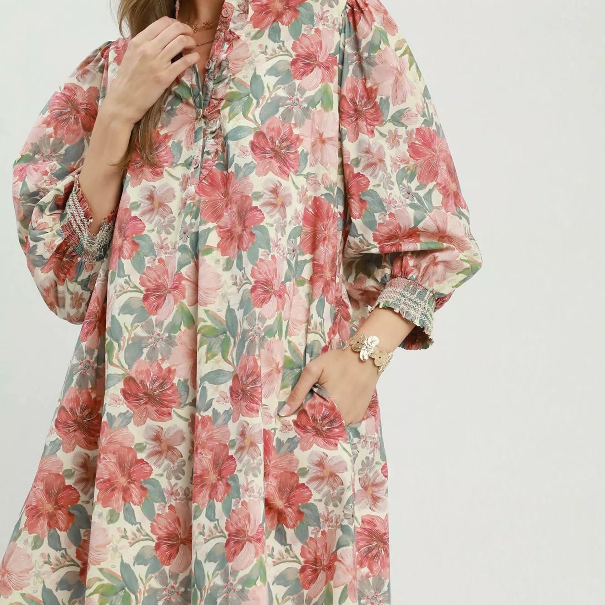 Front view of a loose flowing bohemian Umgee mini dress with a mixed floral print from Solazura Boutique