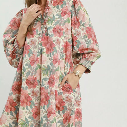 Front view of a loose flowing bohemian Umgee mini dress with a mixed floral print from Solazura Boutique