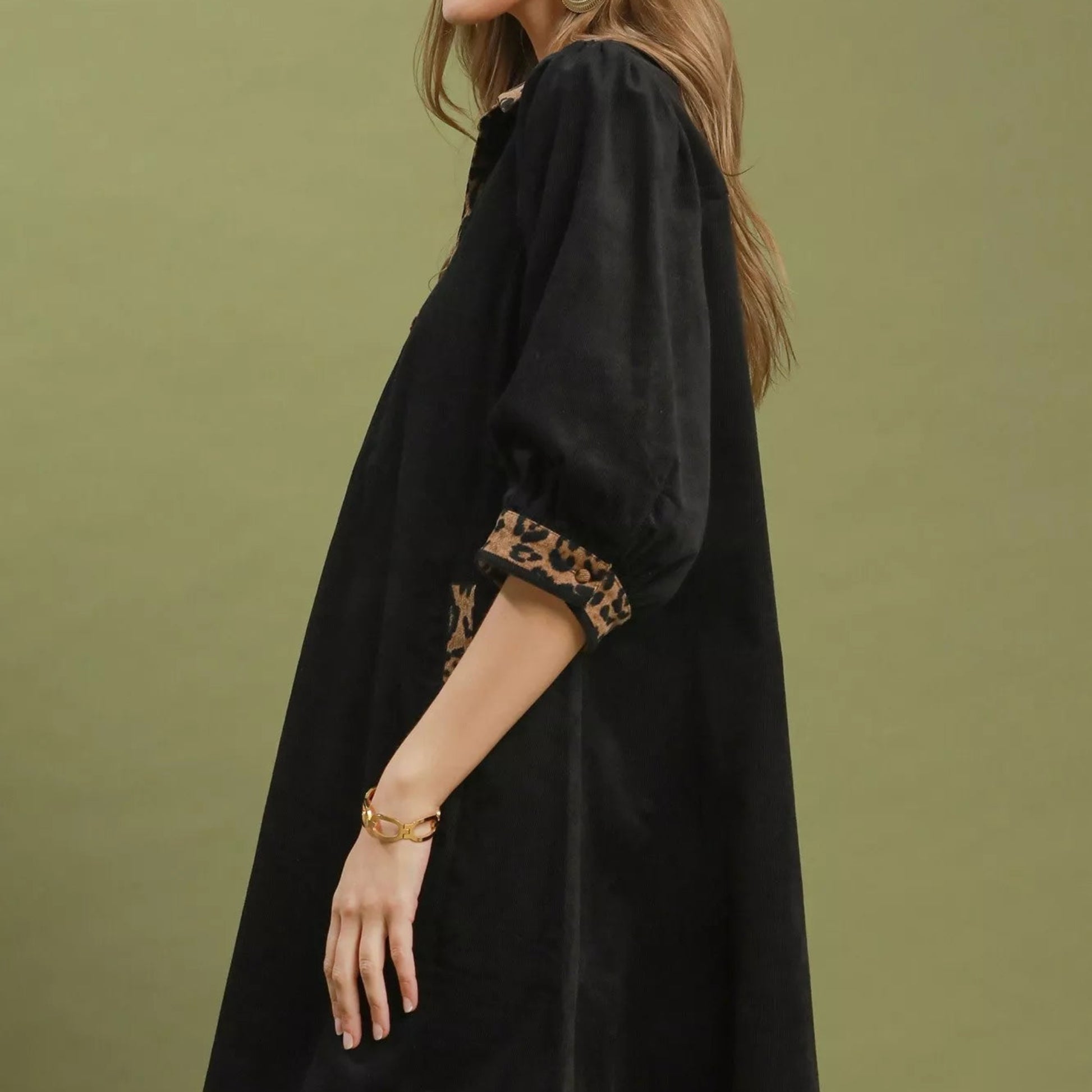 Close up shot of the unique contrast trim stitching on a black Umgee shift dress from Solazura Boutique
