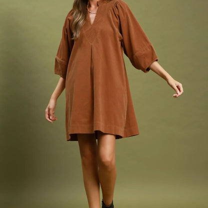 Texture shot of the premium ribbed camel corduroy fabric on an Umgee dress from Solazura Boutique