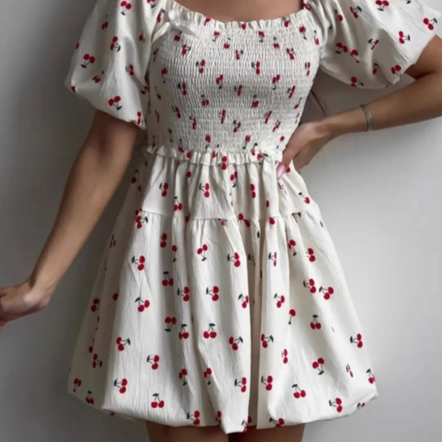 Puff Sleeve Cherry Print Smocked Mini Dress in White - Lifestyle View 1