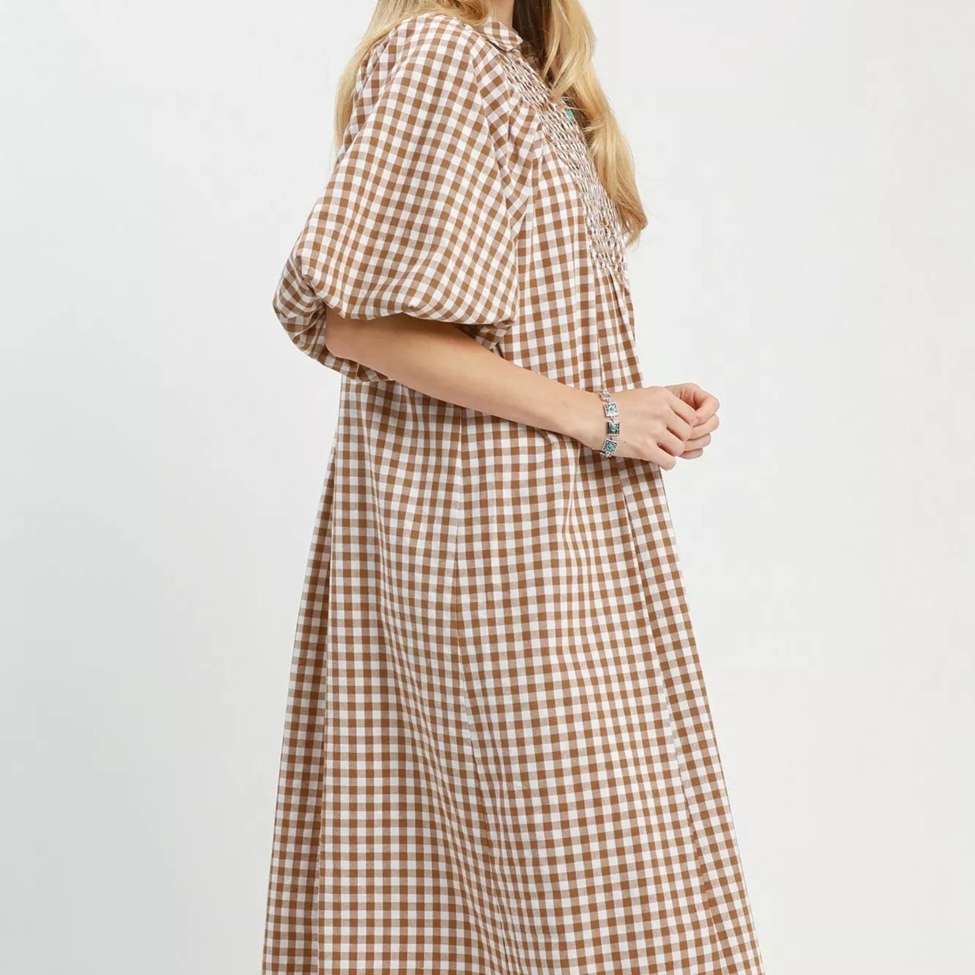 Texture shot of the premium brown plaid pattern fabric on an Umgee midi dress from Solazura Boutique