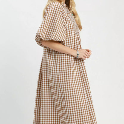 Texture shot of the premium brown plaid pattern fabric on an Umgee midi dress from Solazura Boutique
