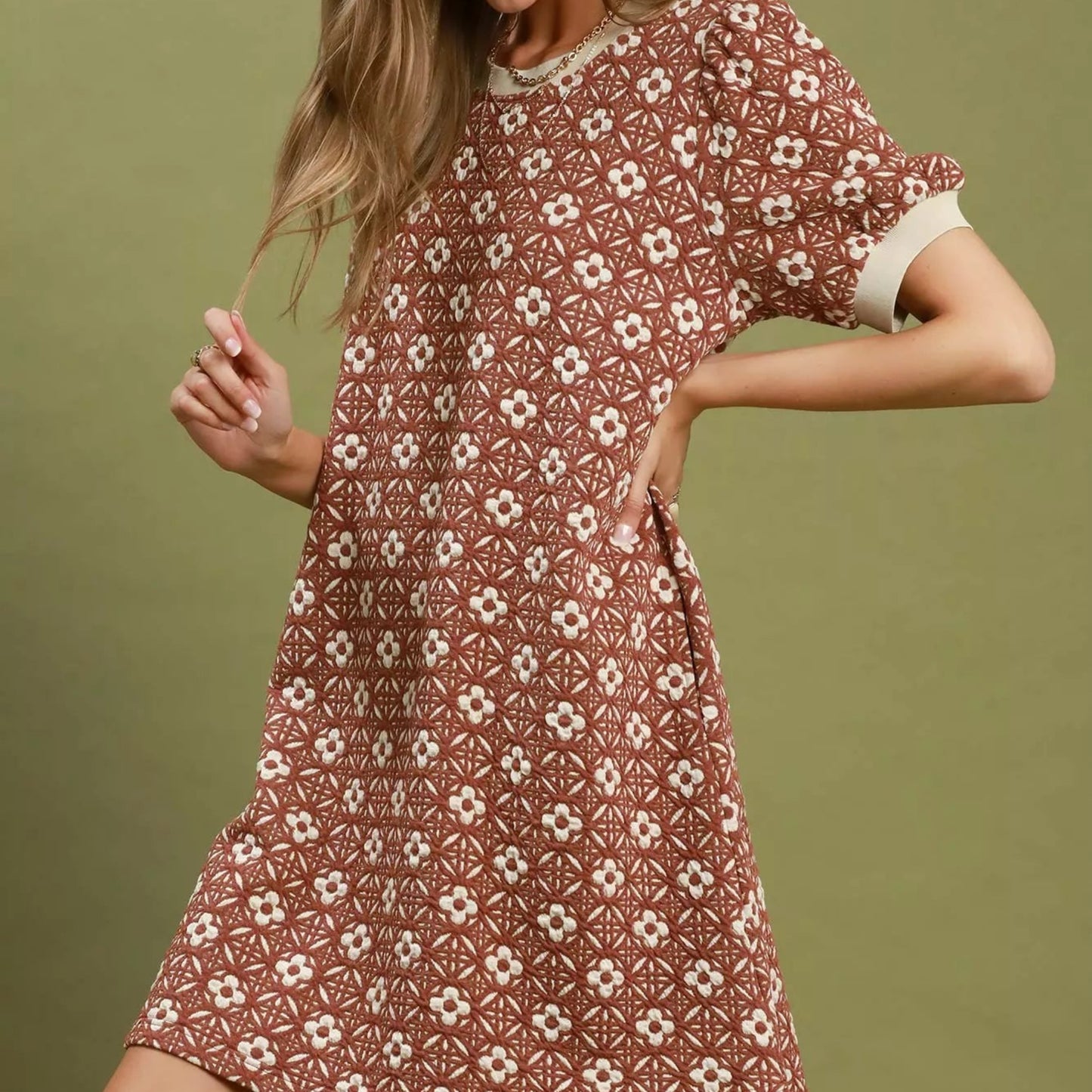 Back view of the rust floral puff sleeve mini dress showing rear bodice fit from Solazura Boutique