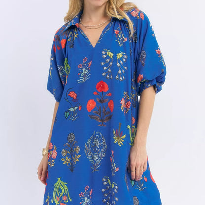 Front view of a loose flowing bohemian Umgee mini dress with a floral encyclopedia print from Solazura Boutique