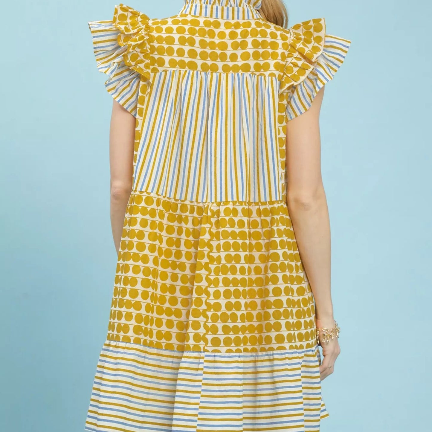 Back view of the breezy mixed pattern Umgee tiered mini dress showing rear fit from Solazura Boutique