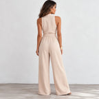 Back view of women’s apricot sleeveless wide-leg jumpsuit with belted waist