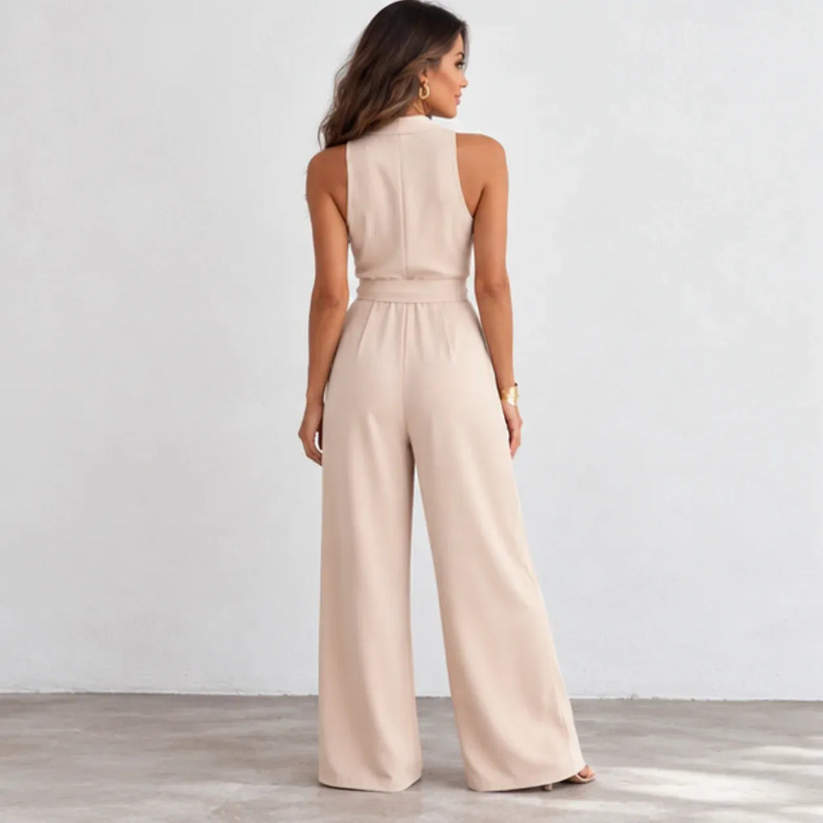 Back view of women’s apricot sleeveless wide-leg jumpsuit with belted waist