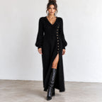 Women’s black fuzzy knit maxi dress with V-neckline, long balloon sleeves, gold button-side detail, and high side slit.