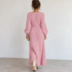 Back view of a pink fuzzy knit maxi dress with long sleeves and soft textured knit fabric.
