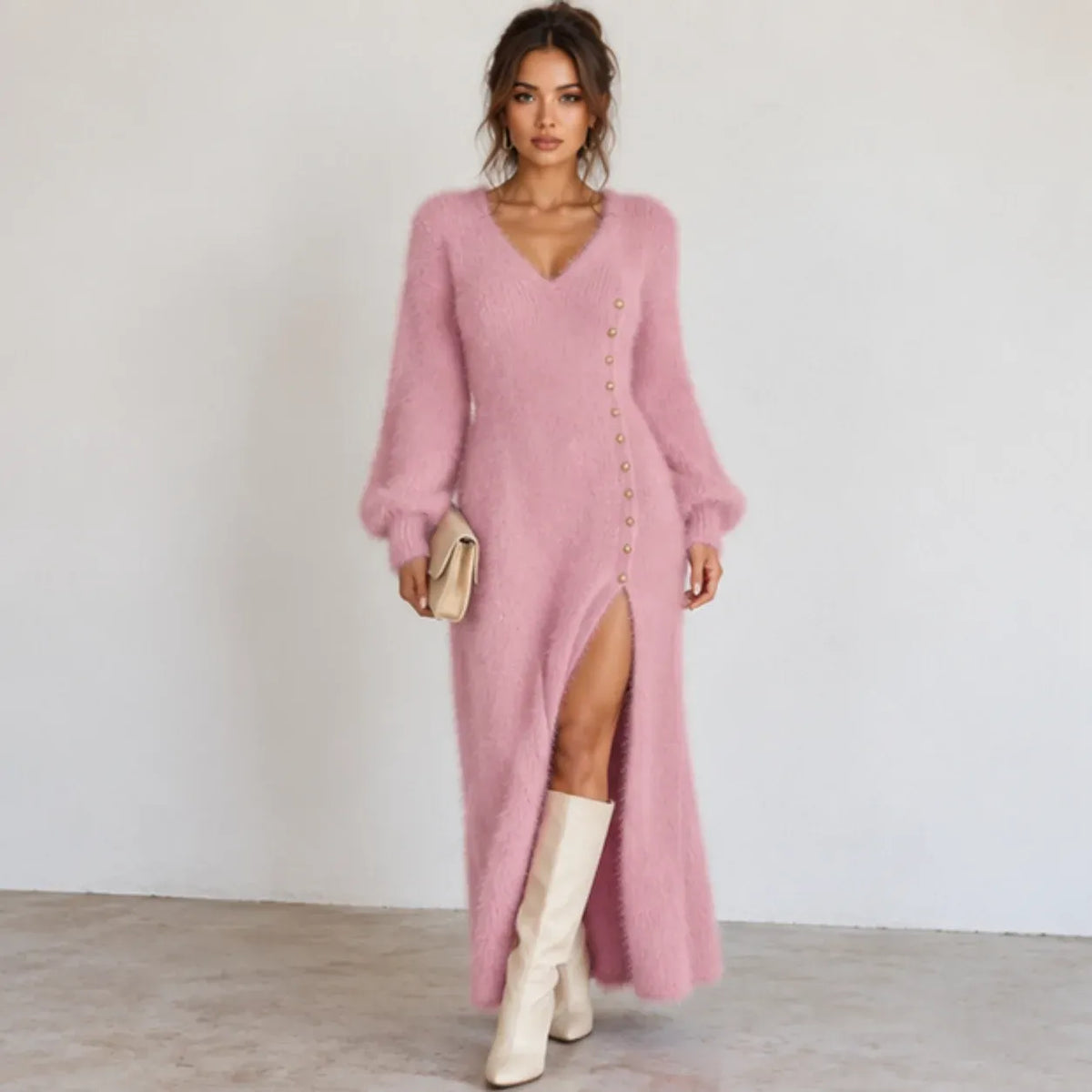 Women’s pink fuzzy knit maxi dress with V-neckline, balloon sleeves, gold side buttons, and high side slit.