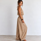 Side view of women’s khaki halter wide-leg linen jumpsuit with smocked waist