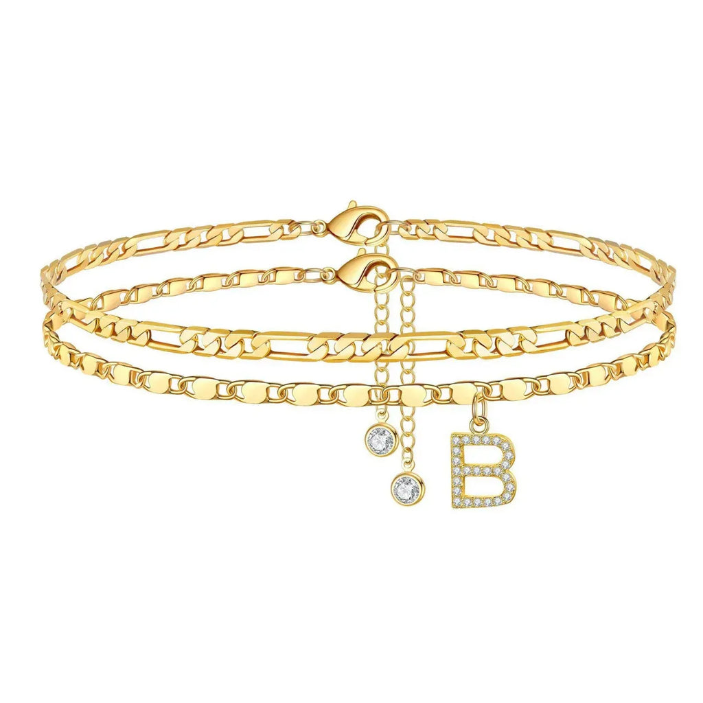 Set of gold anklets with letter 'B' charm on a white background
