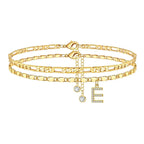 Set of gold anklets with letter 'E' charm on a white background