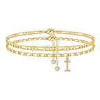 Set of gold anklets with letter 'I' charm on a white background