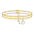 Set of gold anklets with letter 'O' charm on a white background