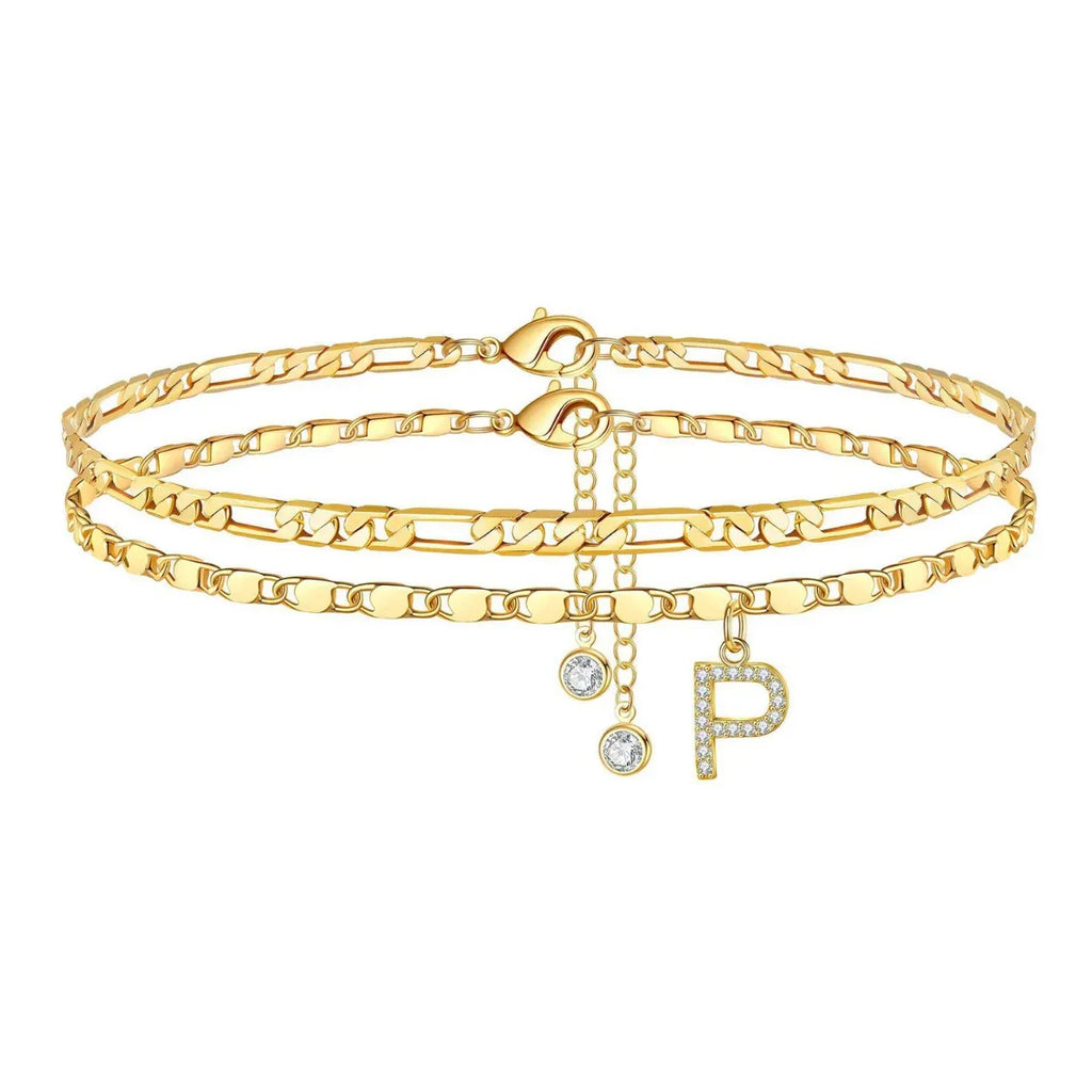 Set of gold anklets with letter 'P' charm on a white background