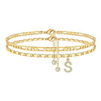 Set of gold anklets with letter 'S' charm on a white background