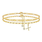 Set of gold anklets with letter 'X' charm on a white background
