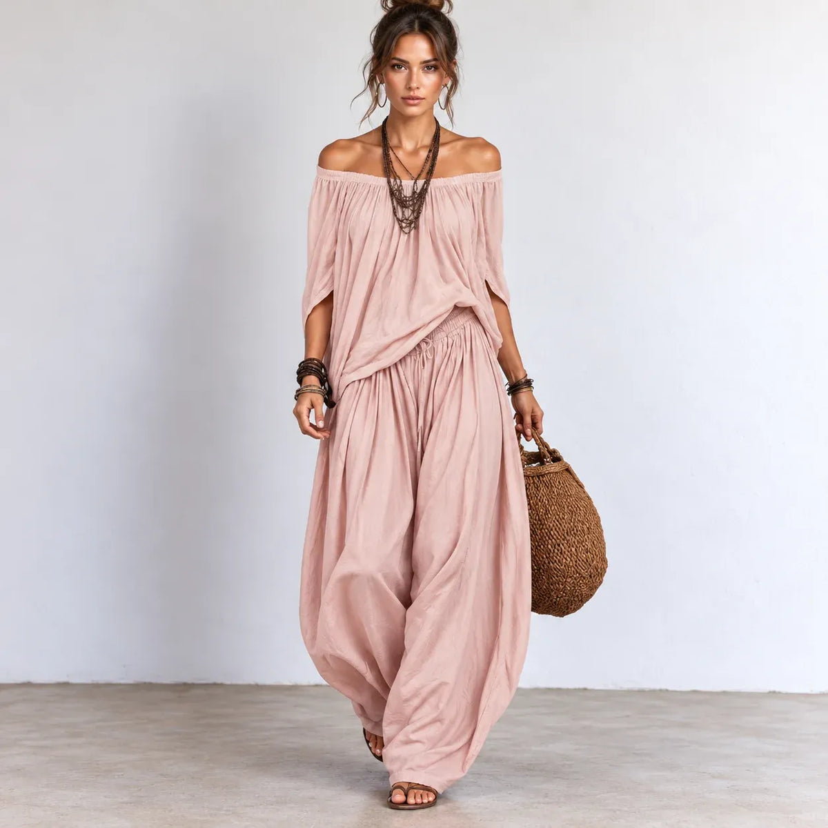 Women’s pink off-shoulder balloon pants two-piece set with matching flowing top and wide-leg pants