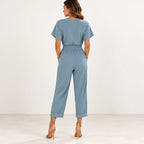 Back view of blue Twist Front V-Neck Two-Piece Set showing short sleeves, elastic waist, pockets, and cuffed pant hems