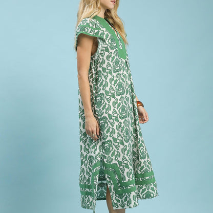 Woman wearing a green and white patterned dress against a light blue background