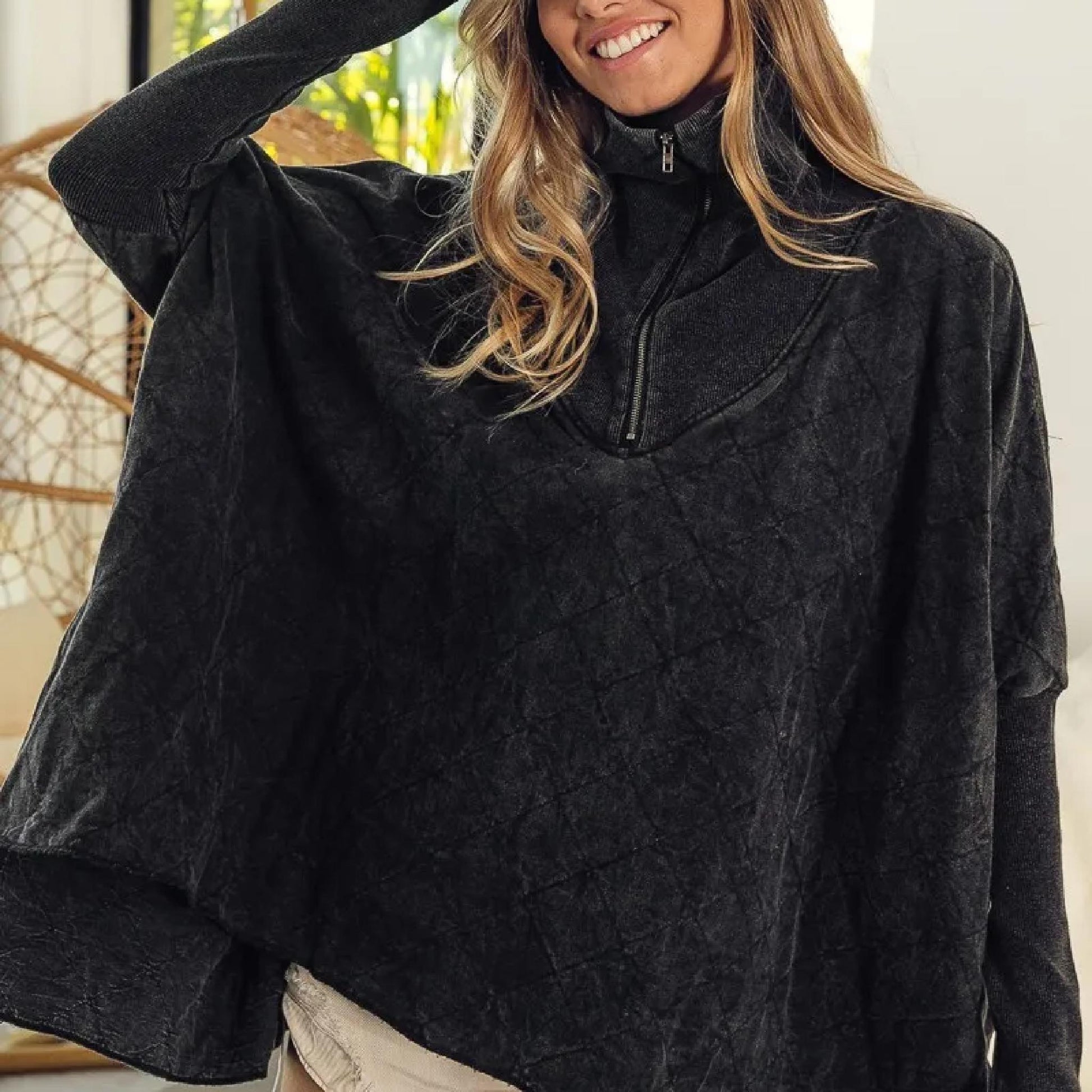 Person wearing a black fleece jacket indoors