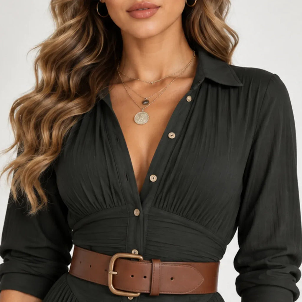 Close-up of women’s black belted button-front maxi dress showing pleated bodice, button details, collar, and brown belt