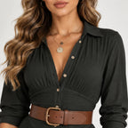 Close-up of women’s black belted button-front maxi dress showing pleated bodice, button details, collar, and brown belt