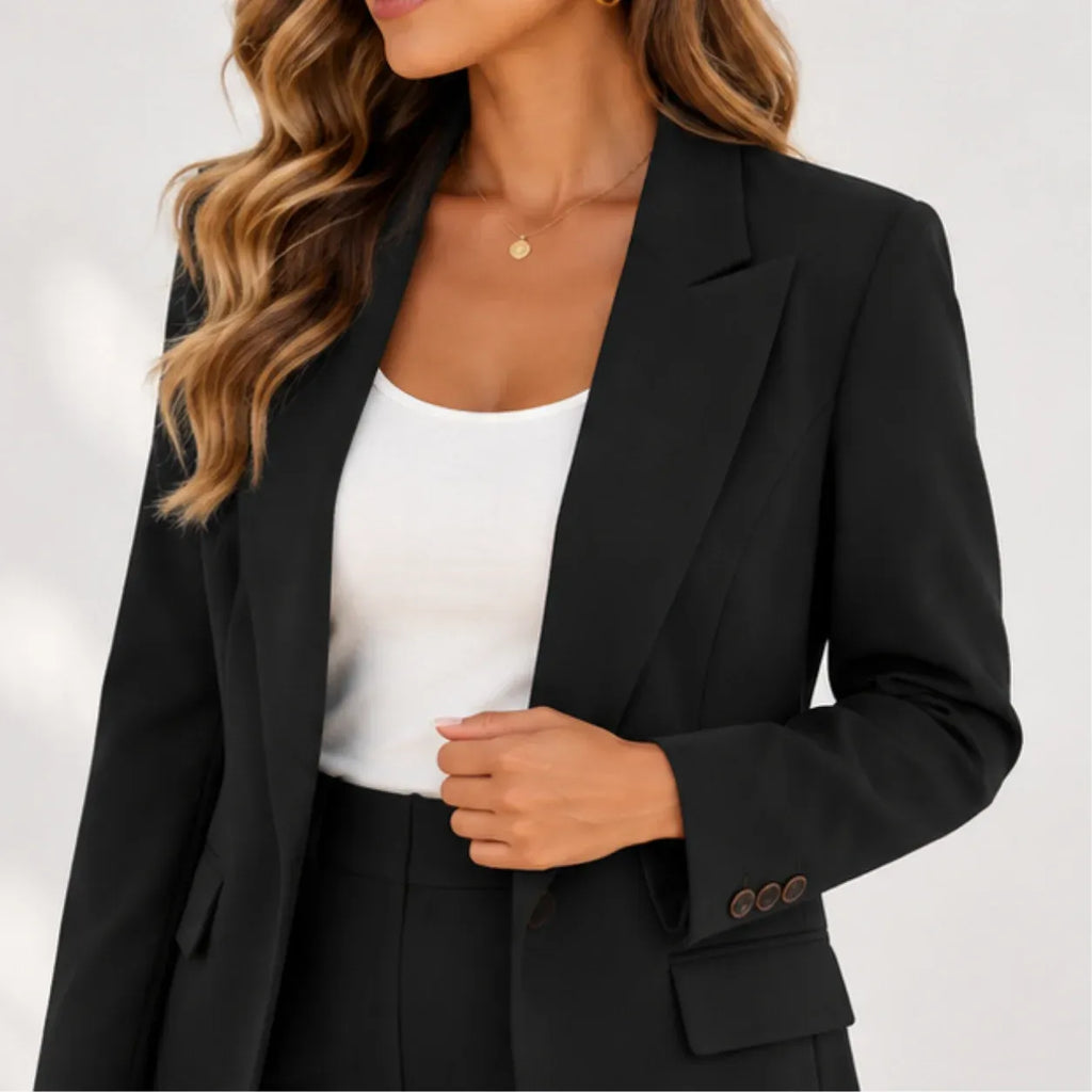 Close-up of women’s black blazer and pants two-piece suit showing blazer lapels, buttons, and pocket details