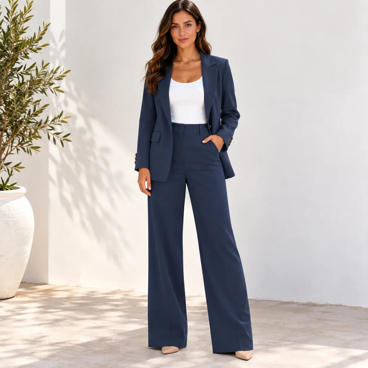 Women’s blazer and pants two-piece suit showing the side profile and wide-leg trousers