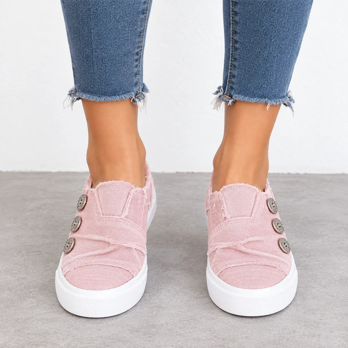 Women’s pink button detail slip-on sneakers with three decorative buttons and white platform soles