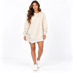 Beige front: Model wearing a beige long sleeve sweater dress with a round neckline and side zipper detail.