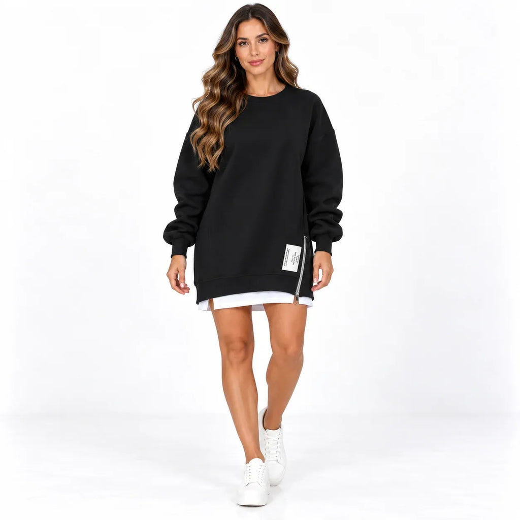 Black front: Model wearing a black sweater dress with long cuffed sleeves, a side zipper, and a white printed label.