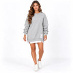 Grey front: Model wearing a grey sweater dress with long sleeves, ribbed trim, and a side zipper.