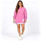 Pink front: Model wearing a pink sweater dress with long cuffed sleeves, a round neckline, and side zipper detail.